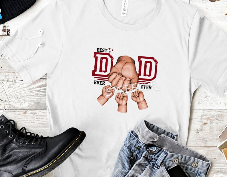 May include: White t-shirt with a red graphic that says "Best Dad Ever" with a hand holding the letters "D" and "A" and three small hands holding the letters "D" and "E".
