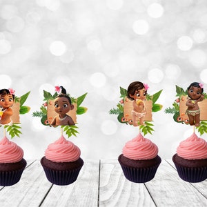 May include: Four cupcakes with pink frosting and brown cupcake liners. Each cupcake has a Moana themed topper with a cartoon image of a baby Moana in a tropical setting.