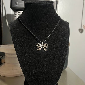 handmade indie coquette black cord necklace with silver bow pendant