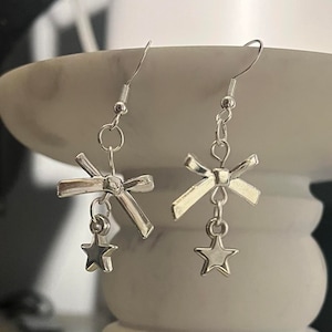 handmade coquette indie silver bow charm and star fish hook plated dangle earrings