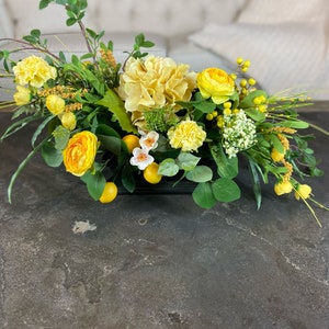 Oblong Yellow Hydrangea, Ranunculus, Lemons, and Greenery Arrangement ...