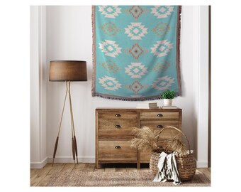 May include: A turquoise and white woven throw blanket with a geometric pattern hangs on a white wall above a wooden dresser with six drawers. A wicker basket sits on the floor in front of the dresser.