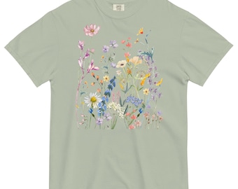 May include: Sage green t-shirt featuring a vibrant floral design. The graphic showcases a variety of wildflowers in shades of pink, purple, yellow, and white. The shirt has a classic crew neck and short sleeves, made of a soft, comfortable material.