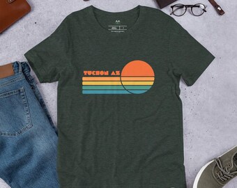 May include: A dark green t-shirt with a retro sunset graphic and the text "Tucson AZ" in white.