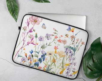 May include: A white laptop sleeve with a watercolor floral design. The design features a variety of flowers in shades of pink, purple, blue, yellow, and green. There are also butterflies and bees in the design.