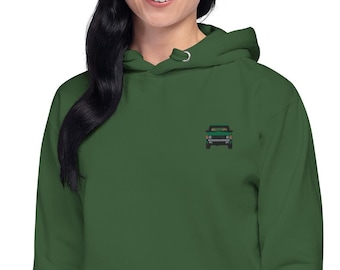 May include: A dark green hooded sweatshirt with a small embroidered image of a green car on the front.