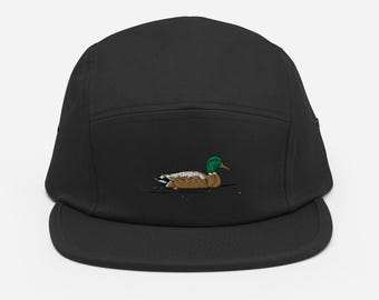 May include: A black 5-panel cap with a brown and green embroidered duck design.
