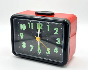 Vintage 80's red and black Casio alarm clock with glowing hands