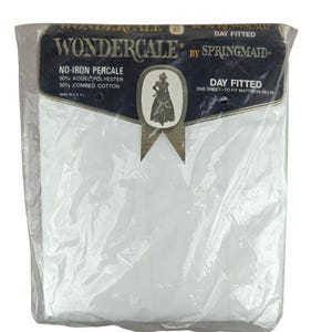 May include: A packaged white day fitted sheet by Springmaid. The packaging includes the text "Wondercale" and "No-Iron Percale" with a blend of polyester and combed cotton. The sheet is designed to fit a 33 x 75 inch mattress.