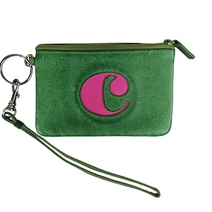 May include: Green leather coin purse with a pink letter "C" design. The purse has a wrist strap and a zipper closure. The hardware is silver-toned. The purse is a small size, perfect for carrying essentials.
