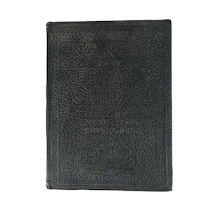 May include: A black, textured hardcover book titled Audel's Engineers and Mechanics Guide 5, featuring embossed lettering that reads Questions, Answers and Illustrations, with a decorative sunburst graphic at the bottom of the front cover.