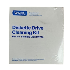 May include: A white box for a Diskette Drive Cleaning Kit. The box has blue text that reads "Diskette Drive Cleaning Kit For 3.5" Flexible Disk Drives." The box also has the Wang logo and company information.