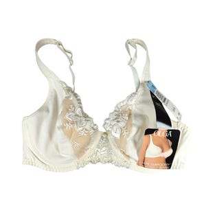 May include: Off-white Olga underwire bra with floral embroidery and adjustable straps. The bra features a sheer panel and a tag with the brand name and product details. The bra is new with tags.