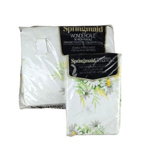 May include: Two sealed packages of Springmaid Wondercale bedding. One package contains a double fitted sheet for a 54x76 inch mattress. The other package contains two standard pillowcases for 20x26 inch pillows. The bedding features a white background with a floral pattern.
