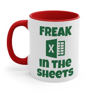 May include: White ceramic mug with a red rim. The mug has a green Microsoft Excel logo and the text "FREAK in the SHEETS".