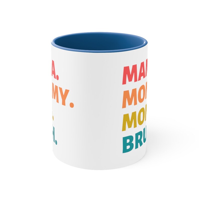 May include: White ceramic coffee mug with a blue rim. The mug has a rainbow design with the text "Make Monday" in a rainbow font.