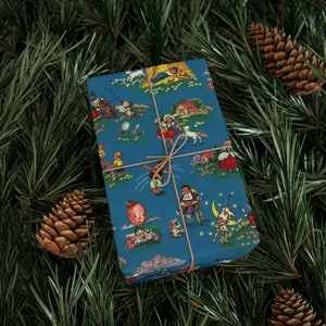 Cute wrapping paper with vintage illustrations depicting different nursery rhymes. The paper is primarily blue.