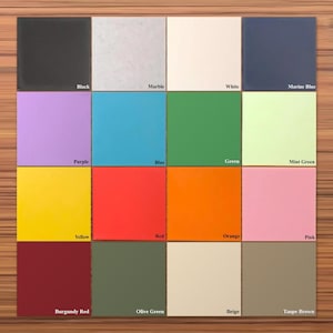 May include: A grid of sixteen square tiles in various solid colors including black, marble, white, marine blue, purple, blue, green, mint green, yellow, red, orange, pink, burgundy red, olive green, beige, and taupe brown with labels.