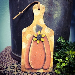 Primitive wood pumpkin cut outs with sunflower.