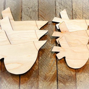 May include: Two sets of wooden bird cutouts, each set stacked on top of each other. The cutouts are unfinished and ready to be painted or stained.