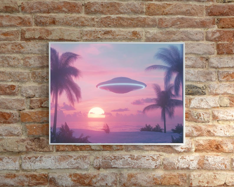 May include: A framed print of a pink and purple sunset over a beach with two palm trees and a flying saucer in the sky.