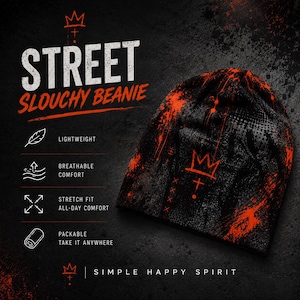 Black and orange grunge beanie featuring distressed graffiti, crown artwork and paint splatter, shown in Street Code product graphic highlighting lightweight breathable comfort, stretch fit and packable design.