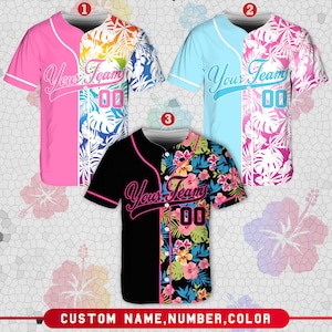 Pode incluir: Três camisas de beisebol com padrões florais tropicais. As camisas são rosa, azul e preta com desenhos florais brancos. As camisas têm o texto "Your Team" e o número "00" na frente.
