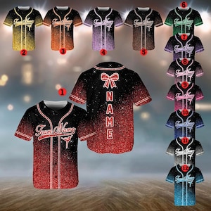 May include: A collection of baseball jerseys in various colors, including red, black, gold, and blue. Each jersey features the text "Team Name" and a dancer graphic. The back of one jersey displays the word "NAME" vertically.