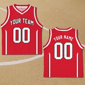 May include: Red basketball jersey with white trim and black accents. The front of the jersey has "YOUR TEAM" and "00" printed in white. The back of the jersey has "YOUR NAME" and "00" printed in white.