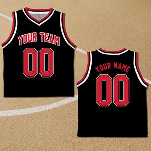 May include: Black basketball jersey with red and white trim. The front of the jersey has the text "YOUR TEAM" and the number "00". The back of the jersey has the text "YOUR NAME" and the number "00".