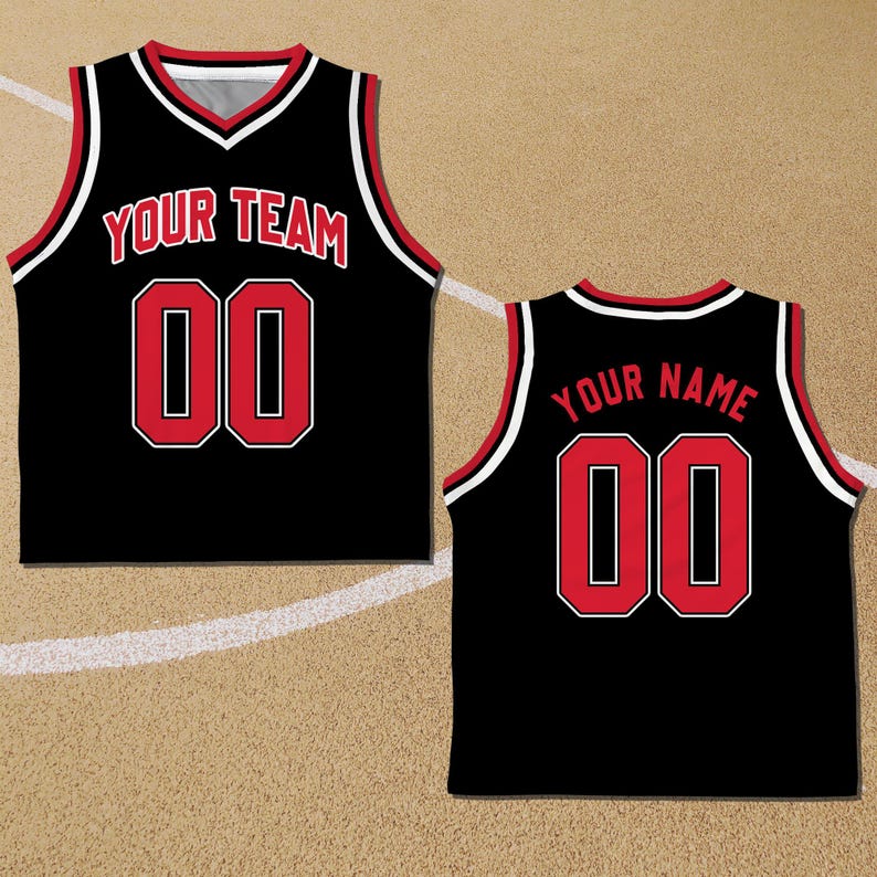May include: Black basketball jersey with red and white trim. The front of the jersey has the text "YOUR TEAM" and the number "00". The back of the jersey has the text "YOUR NAME" and the number "00".
