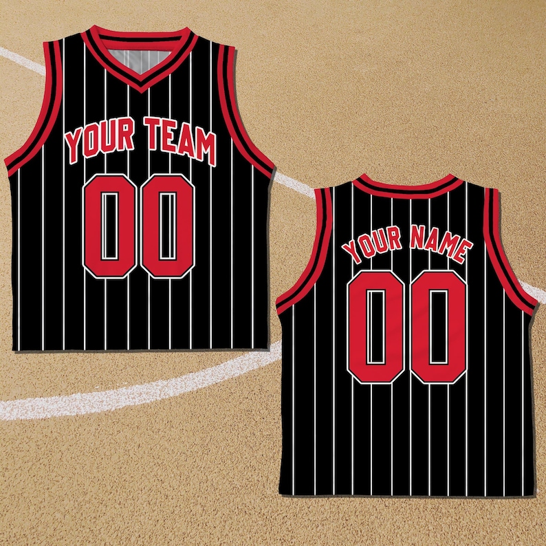 May include: Black and red basketball jersey with white vertical stripes. The front of the jersey says "YOUR TEAM" and has the number "00" in red. The back of the jersey says "YOUR NAME" and has the number "00" in red.