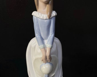 Nao By Lladro Daisa 1982 Figurine Girl Holding A Hat dressed in long white and blue dress