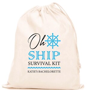 May include: A cream-coloured drawstring bag with the words "Oh Ship Survival Kit" in black and blue. A blue ship wheel graphic is above the word "Ship". The text "Katie's Bachelorette" is at the bottom.
