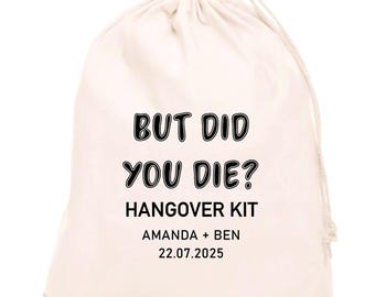 May include: A cream-colored drawstring bag with the text "BUT DID YOU DIE? HANGOVER KIT" in black. Below the text are the names "AMANDA + BEN" and the date "22.07.2025". The bag is made of a soft, natural fabric.