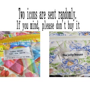 May include: Two fabric pouches with different patterns are shown. One has a colorful, quilted design with a yellow zipper and the text "today, mood feel the warm." The other pouch has a white floral pattern and the text "the jolly house."