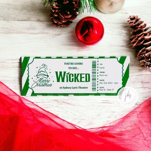 May include: A green and white ticket for the musical "Wicked" at the Sydney Lyric Theatre. The ticket features "Merry Christmas" and a Santa hat graphic. Details include the recipient's name, date, time, and seat number. Red fabric and Christmas decorations are in the background.
