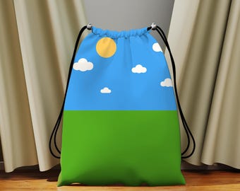 May include: A drawstring backpack featuring a blue sky with a yellow sun and white clouds over a green field. The bag has black drawstrings and is made of a soft material.