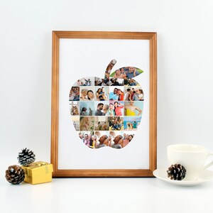 Op de afbeelding: Een ingelijst fotocollage van een familie in de vorm van een appel. De collage is gemaakt van veel kleinere foto's van verschillende mensen, die allemaal glimlachen en er gelukkig uitzien. De lijst is van lichtbruin hout.