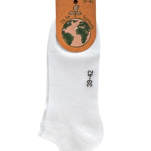 May include: White ankle socks with a brown tag that says "100% Bio Baumwolle" and "39-42". The tag has a green drawing of the Earth with a plant growing out of it.