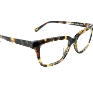 May include: Tortoiseshell eyeglasses with a square frame and clear lenses.