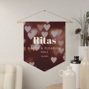 May include: A brown banner with a heart-shaped bokeh background. The banner reads "Ritas Dance & Pleasure Hall Valaris".