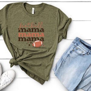 May include: A green t-shirt with the text "football mama mama mama" and a football graphic.