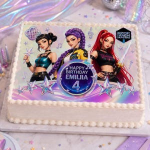 May include: A rectangular sheet cake with white frosting borders featuring an edible print of three animated characters with music notes and stars. A circular graphic in the center displays the text Happy Birthday Emiliia 4 and a logo for K-Pop Demon Hunters.