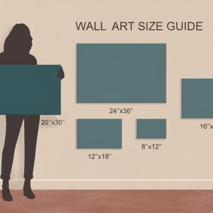 Może przedstawiać: Przewodnik po rozmiarach grafik ściennych z wymiarami w calach. Przewodnik zawiera rozmiary takie jak 20"x30", 24"x36", 16"x24", 12"x18" i 8"x12". Sylwetka osoby trzyma pł&oacute;tno 50.8cm x 76.2cm. Tekst "WALL ART SIZE GUIDE" znajduje się na g&oacute;rze.