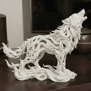 May include: A white, stylized sculpture of a howling wolf. The wolf is depicted in a dynamic pose, with its head raised and mouth open. The sculpture has a flowing, almost flame-like design, giving it a unique and artistic appearance. The sculpture is a decorative item.