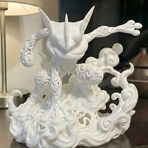 May include: A white ceramic mug with a black handle and the text "But First, Coffee" in a black, handwritten-style font. The mug is on a white surface.