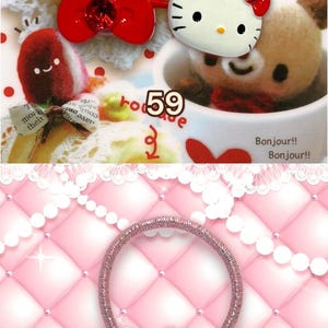 May include: A collection of hair accessories featuring cartoon characters. The image includes a green hair tie with a red apple charm, a Hello Kitty hair tie with a pink bow, and a red hair tie with a Hello Kitty face.