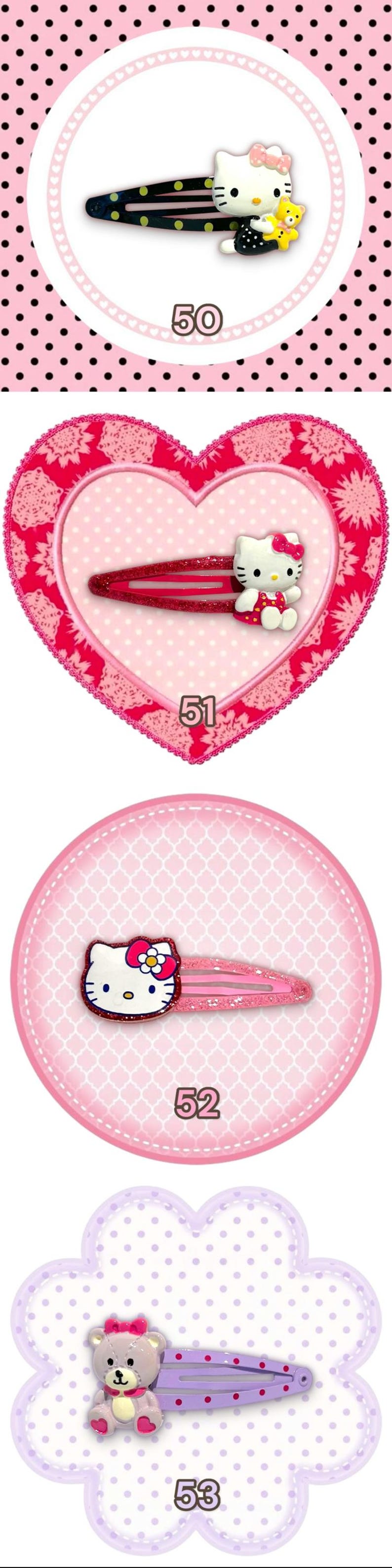 May include: A collection of four hair clips featuring cartoon characters. The clips include Hello Kitty and a teddy bear. The clips are in various colors, including black, pink, and purple. Each clip is set against a decorative background.