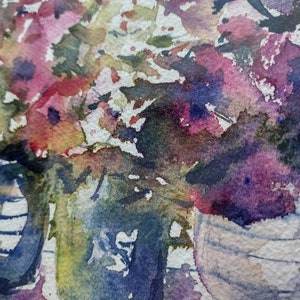 May include: Abstract watercolour painting of pink, purple and blue flowers in a vase. The flowers are painted in a loose, expressive style, with splashes of colour and white space.